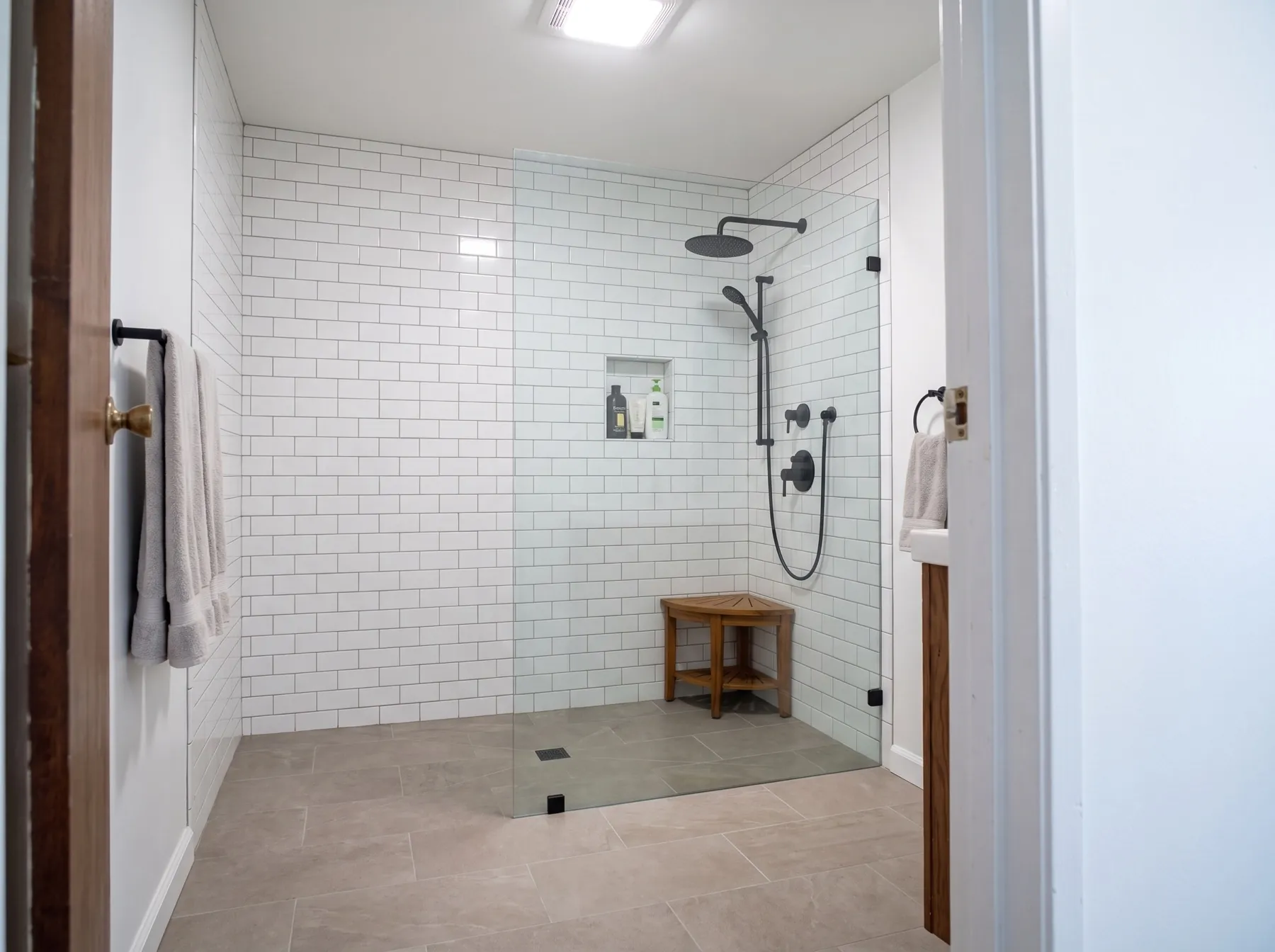 After: bright remodeled bathroom with walk-in tiled shower
