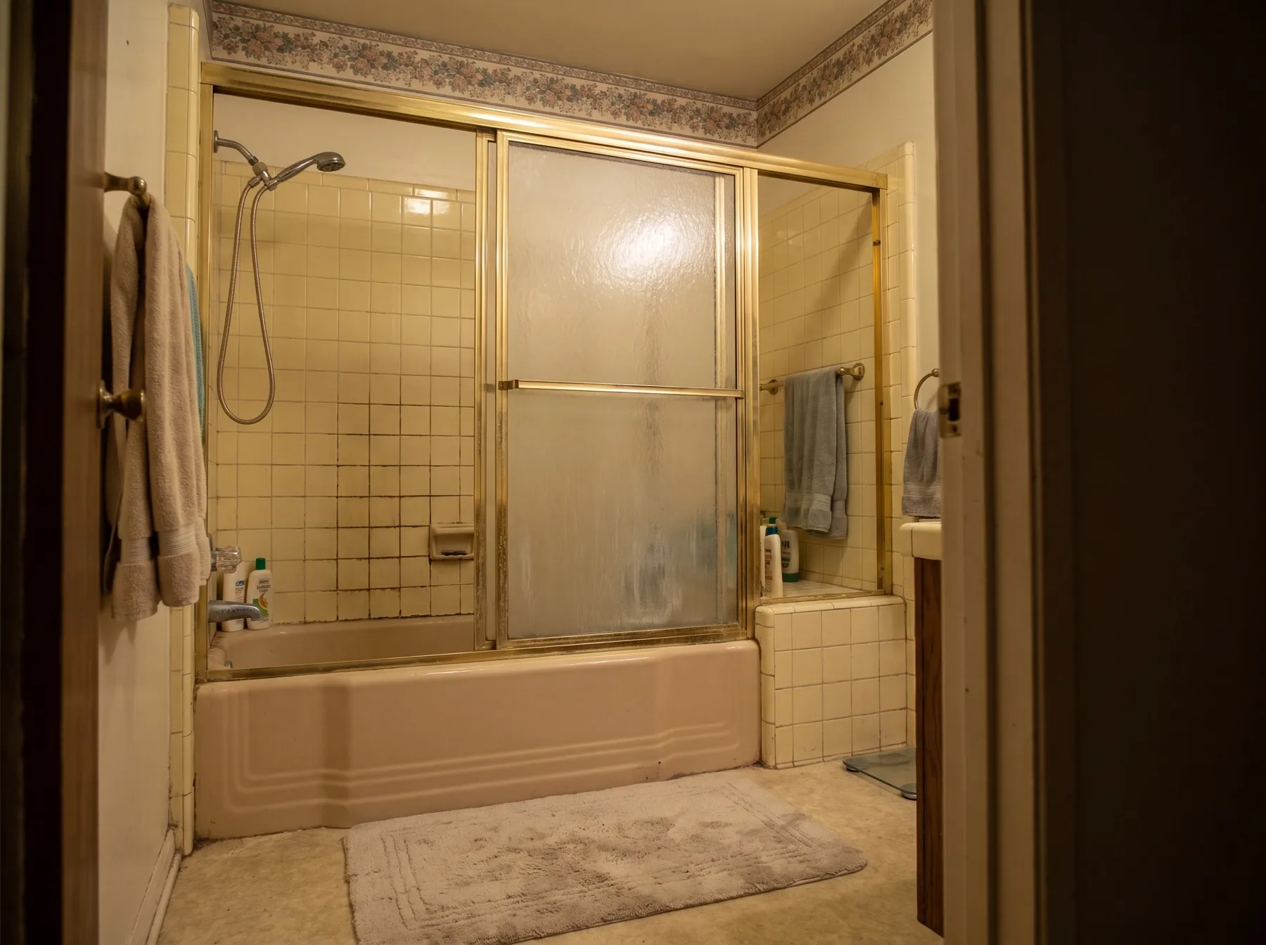 Before: dated bathroom with worn tub and old fixtures
