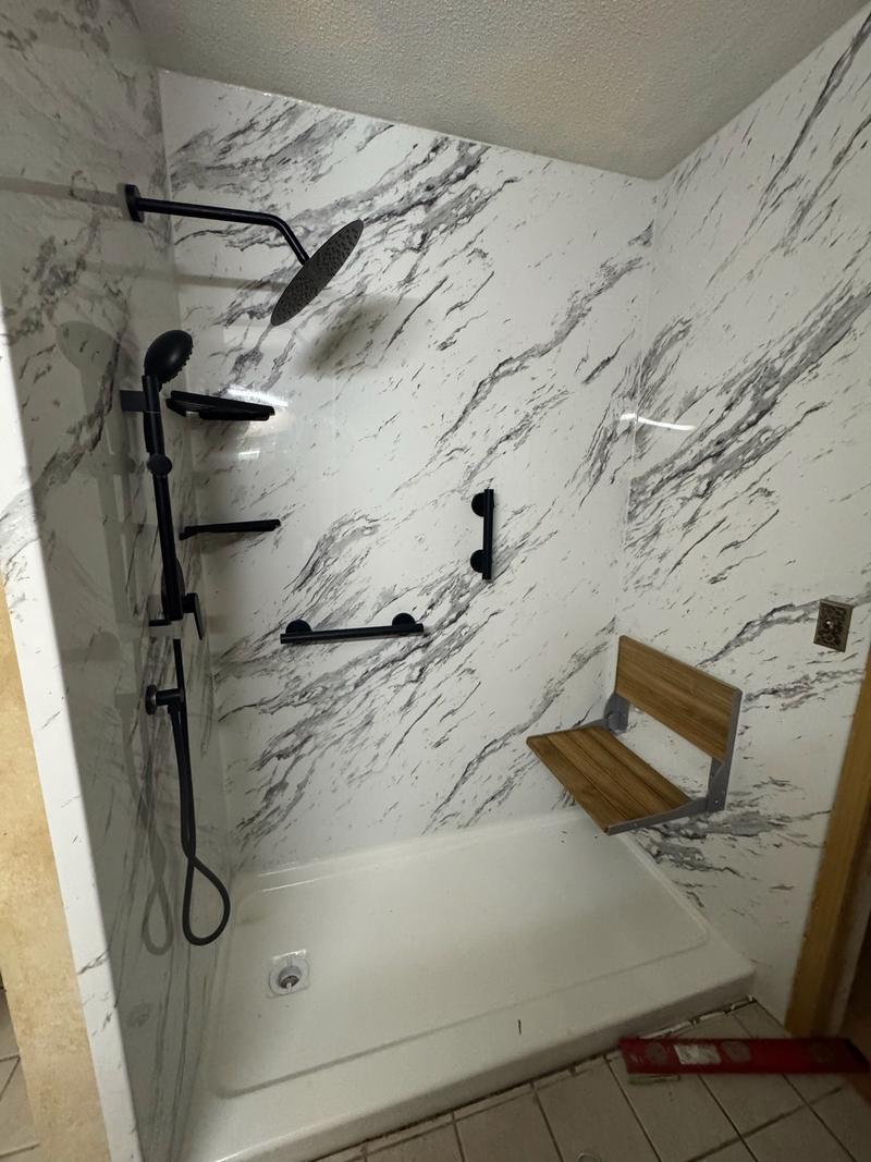 Real HISA grant tub to shower conversion in Charlotte with grab bars, a fold down seat, a handheld shower head and no door