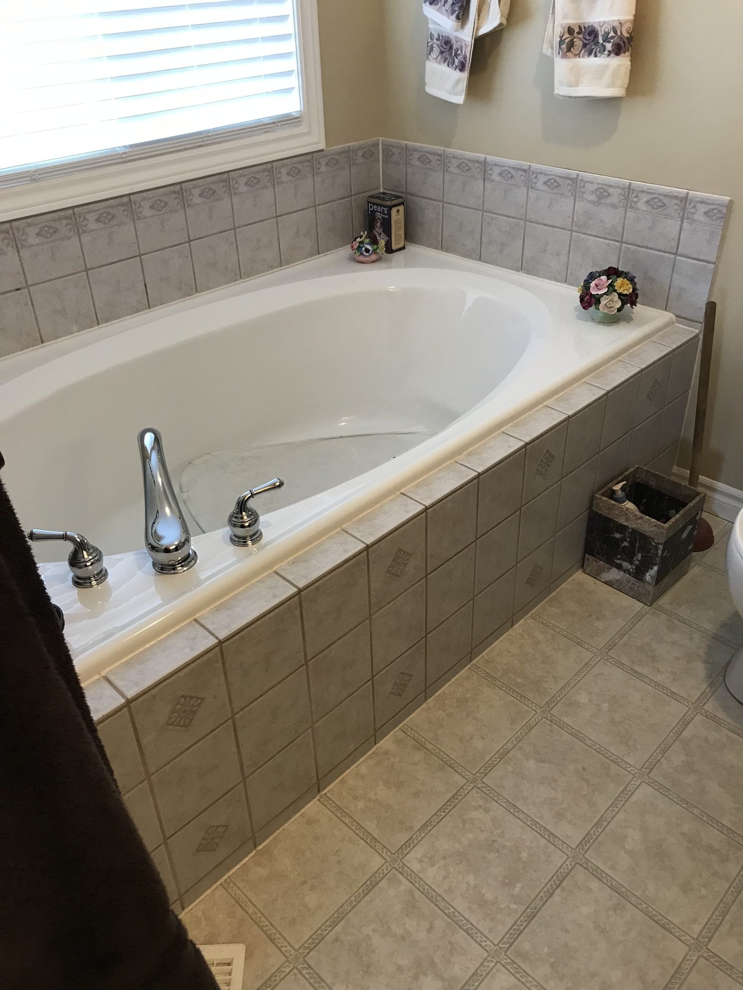 Before: an outdated tiled garden tub